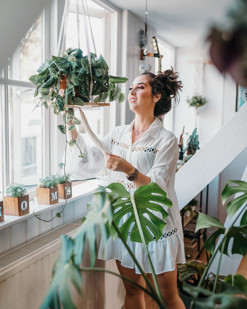 Woman taking care of her plants at home