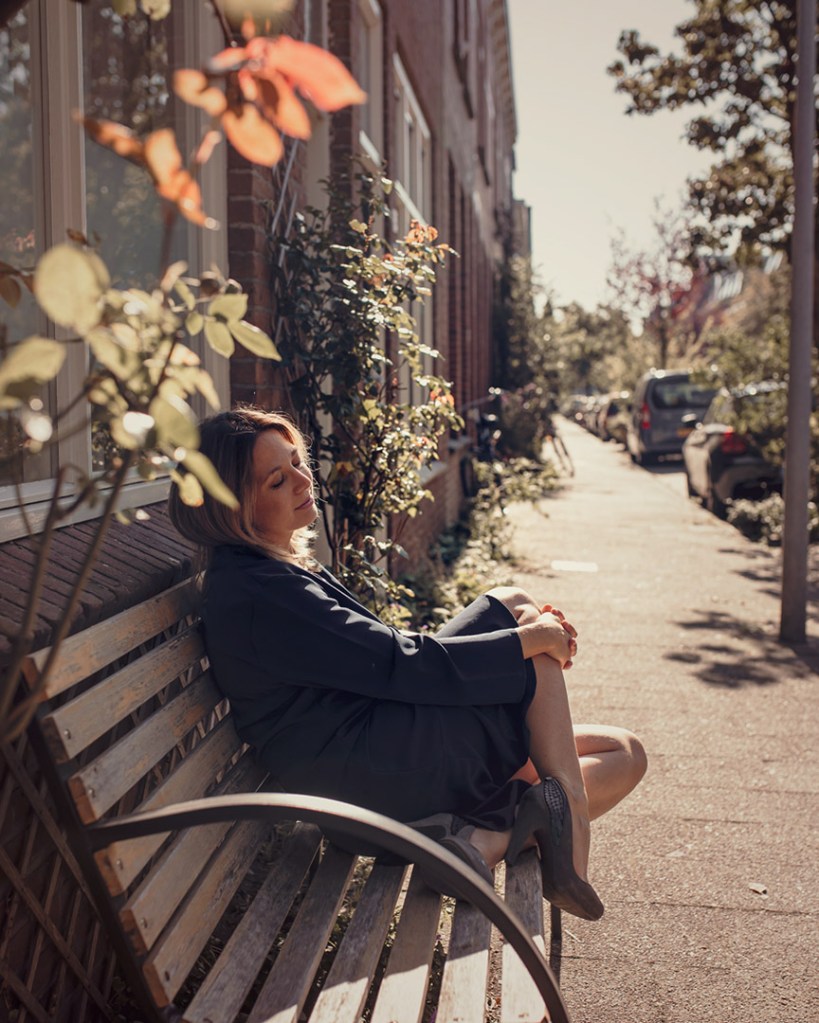 Woman Sitting on a bench city and sunset